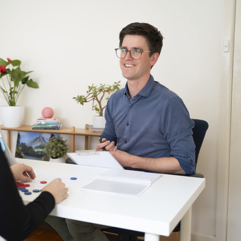 A man smiling during an assessment appointment