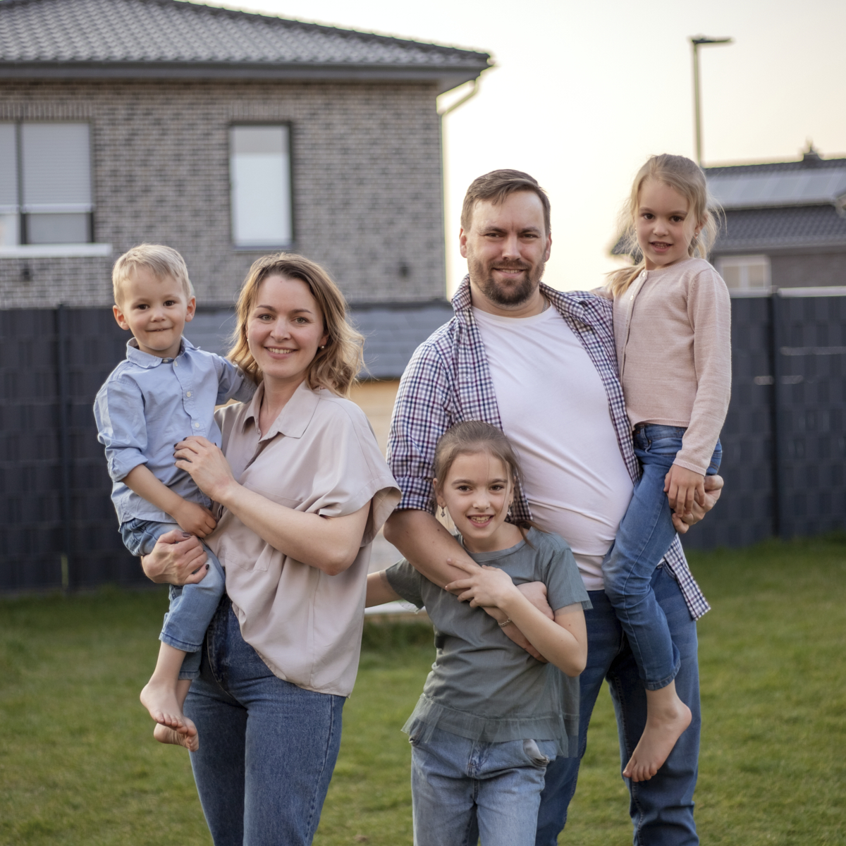 family portrait. happy family mom, dad, daughter, son are relaxing and having fun in the backyard of their house